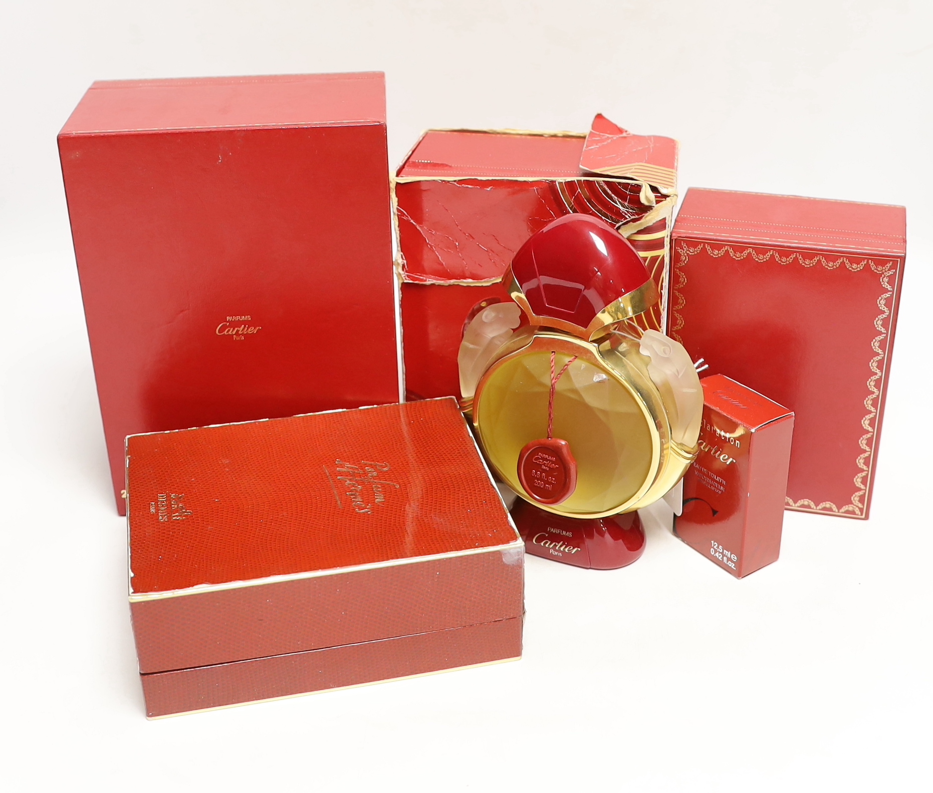 Four bottles of Cartier ‘Panthere’ perfume (three boxed boxed) plus a small bottle of Cartier eat de toilette, and a boxed bottle of Hermes, Paris perfume.